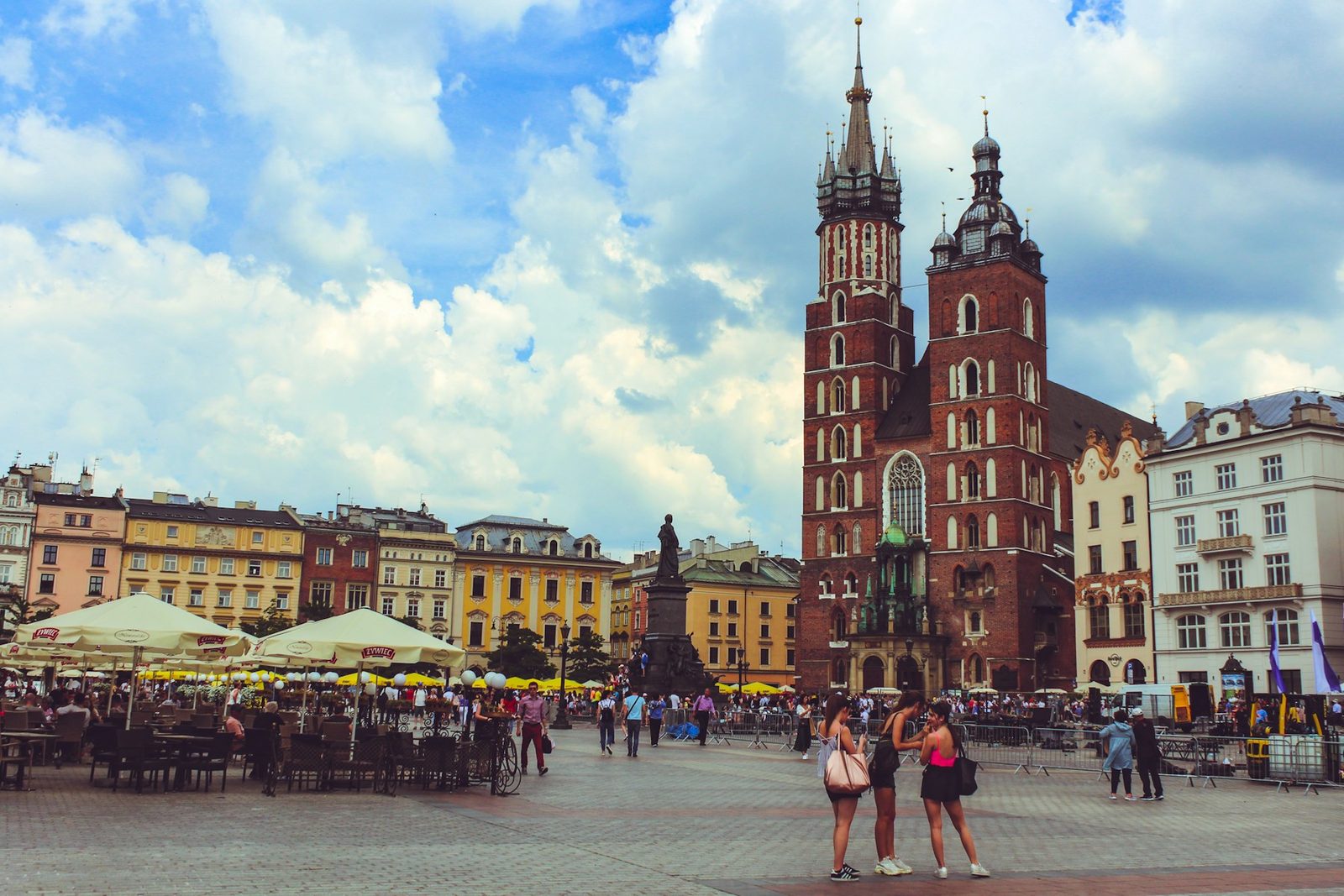 The Main Market Square in Krakow, Poland, historic townhouses ringing the open plaza.
